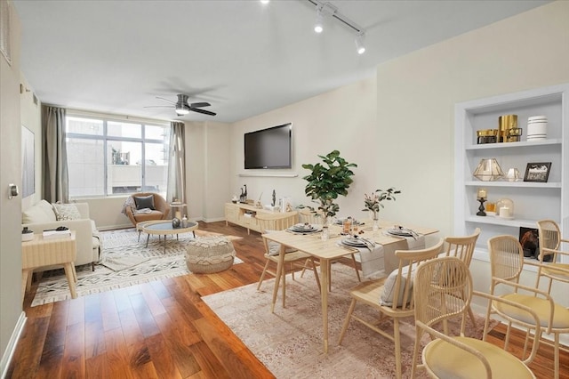 living room featuring ceiling fan and hardwood / wood-style floors