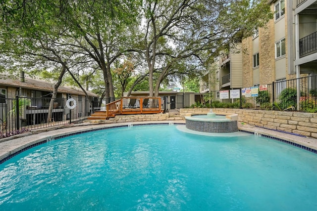 view of swimming pool featuring a deck