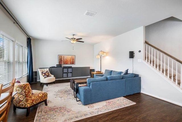 living room with dark hardwood / wood-style floors and ceiling fan