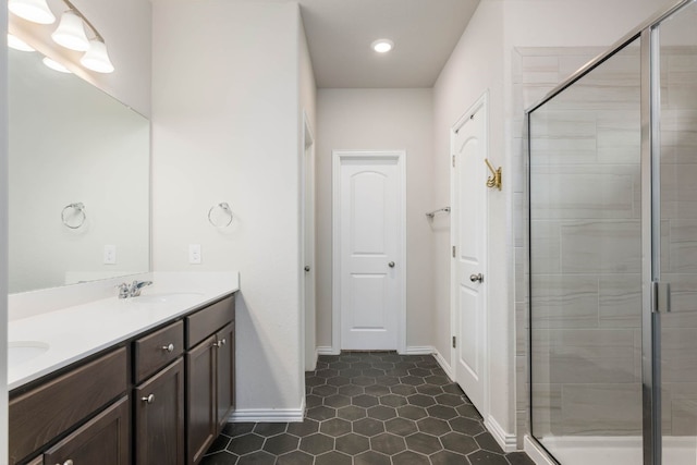 bathroom featuring walk in shower, tile patterned flooring, and dual bowl vanity