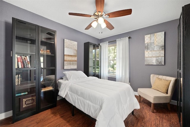 bedroom featuring ceiling fan and dark hardwood / wood-style flooring