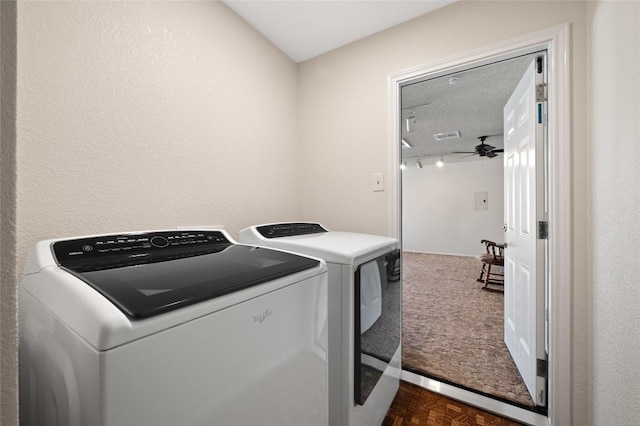 clothes washing area with washer and dryer and dark parquet floors