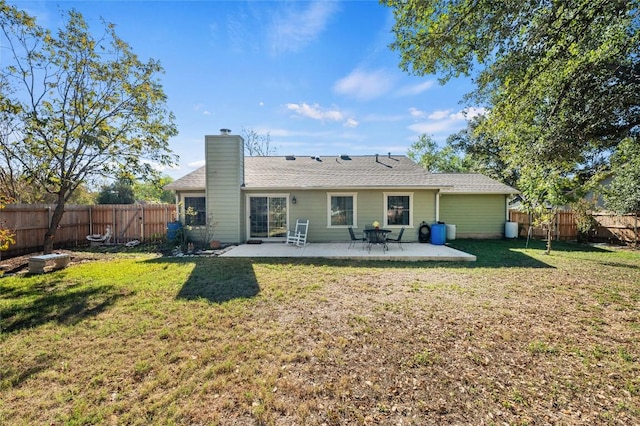 rear view of house featuring a patio area and a lawn