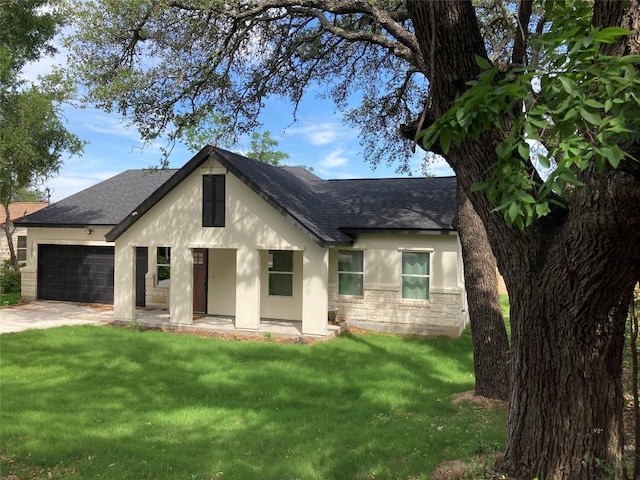 view of front of house with a garage and a front lawn