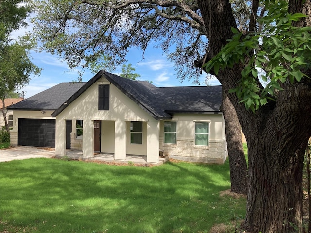 view of front of property with a garage and a front yard