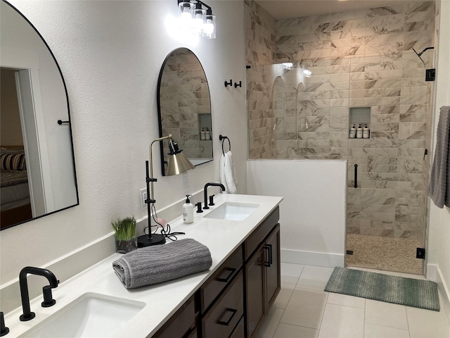 bathroom featuring a shower with door, tile patterned flooring, and vanity