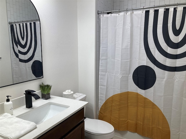 bathroom featuring toilet, a shower with shower curtain, and vanity