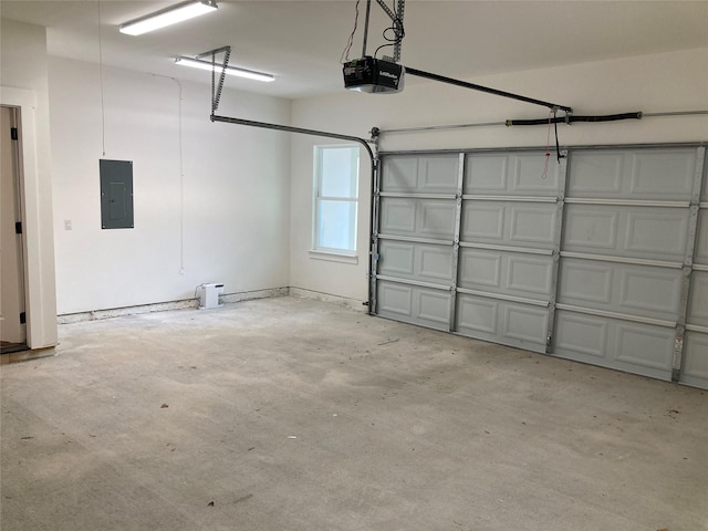 garage with a garage door opener and electric panel