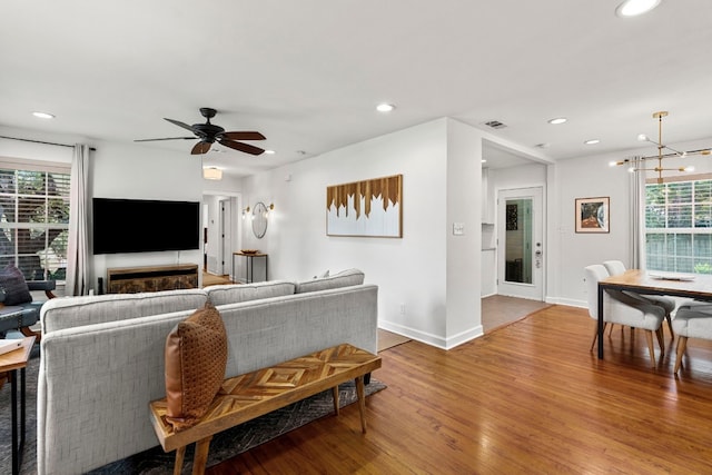 living room with wood-type flooring, plenty of natural light, and ceiling fan