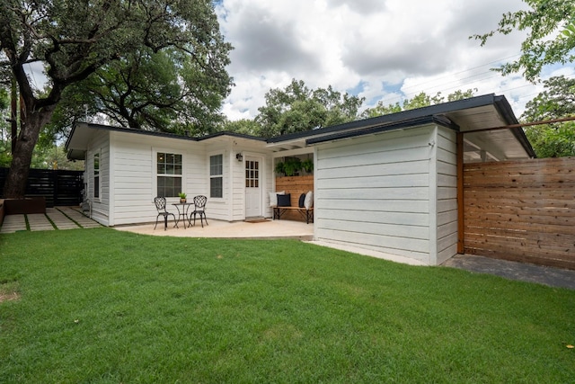 back of house featuring a yard and a patio