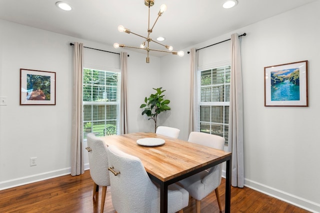 dining area featuring dark wood-type flooring and a chandelier