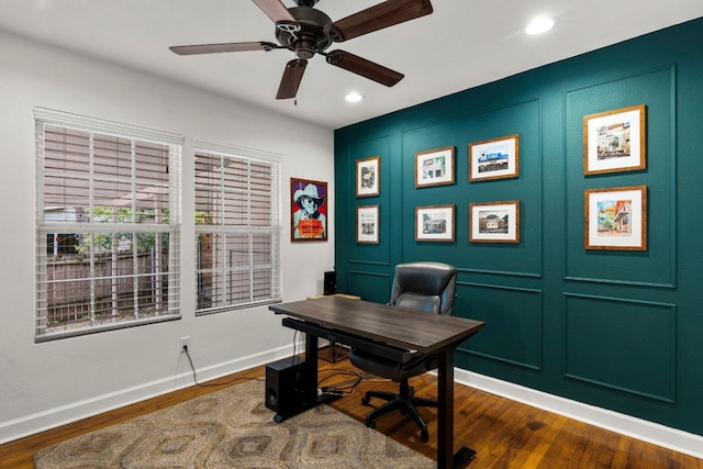 home office with dark hardwood / wood-style floors and ceiling fan