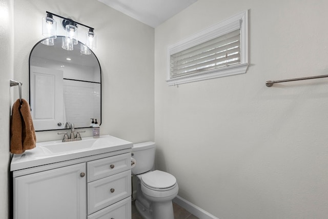 bathroom with vanity, toilet, and a shower