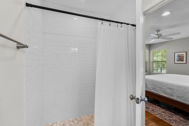 bathroom with hardwood / wood-style floors, ceiling fan, and a shower with curtain