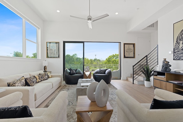 living room featuring ceiling fan and light hardwood / wood-style flooring