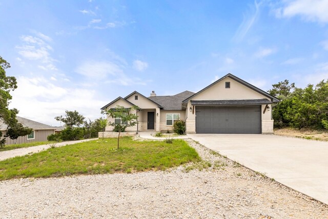 view of front of home featuring a garage and a front lawn