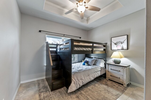 tiled bedroom with a raised ceiling, crown molding, and ceiling fan