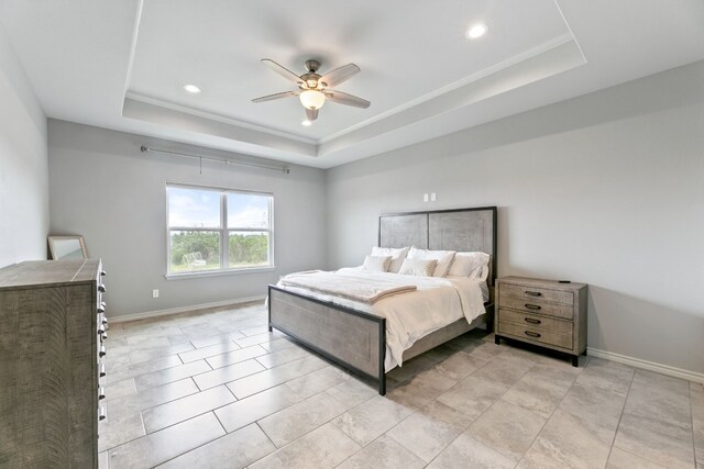 bedroom featuring ceiling fan, a raised ceiling, and light tile patterned floors