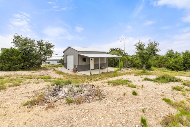 exterior space featuring an outbuilding and a carport