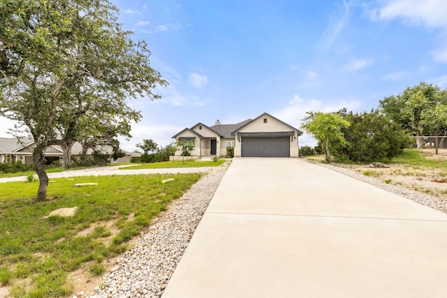 view of front of home featuring a garage and a front yard