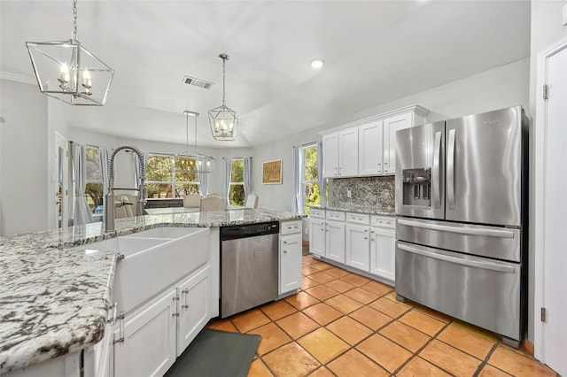 kitchen featuring visible vents, hanging light fixtures, an inviting chandelier, appliances with stainless steel finishes, and white cabinetry