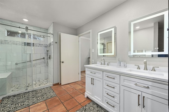 full bathroom featuring double vanity, a stall shower, and a sink