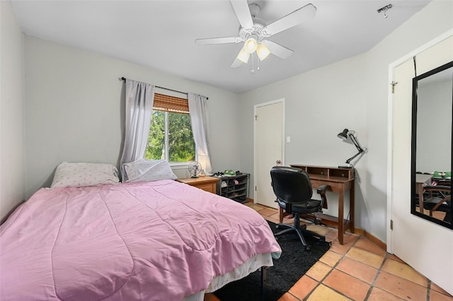 bedroom featuring light tile patterned floors, ceiling fan, and baseboards