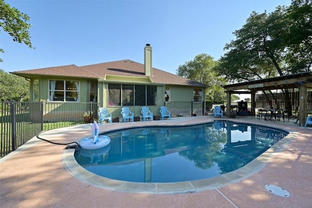 view of pool featuring a fenced in pool, a sunroom, a patio area, and fence