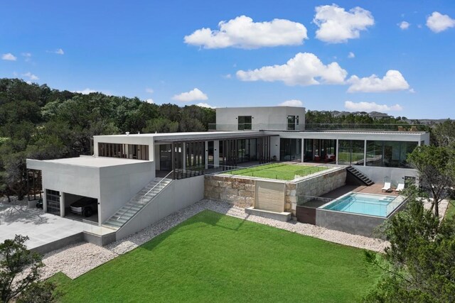 rear view of property with a yard and a patio area