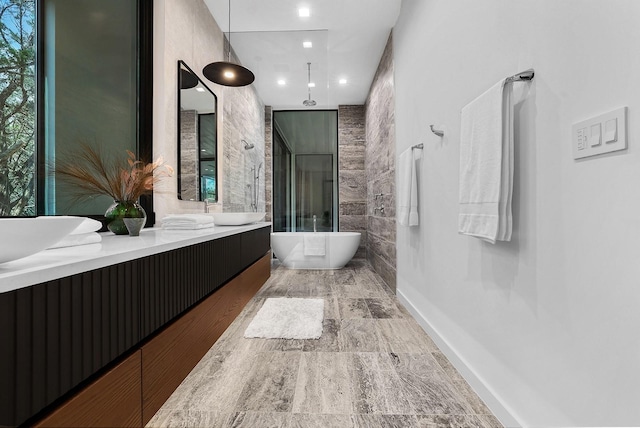 bathroom with a freestanding bath, double vanity, and a walk in shower