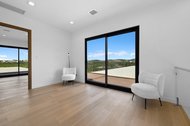 sitting room with light hardwood / wood-style flooring