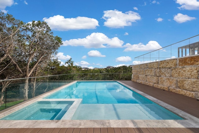 view of swimming pool featuring an in ground hot tub