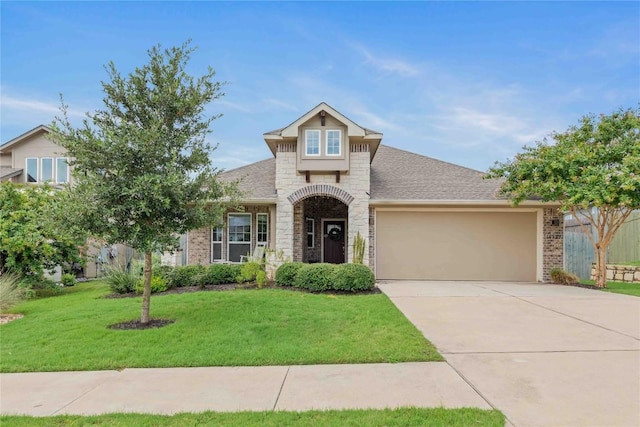 view of front of property featuring a garage, concrete driveway, stone siding, a front lawn, and brick siding