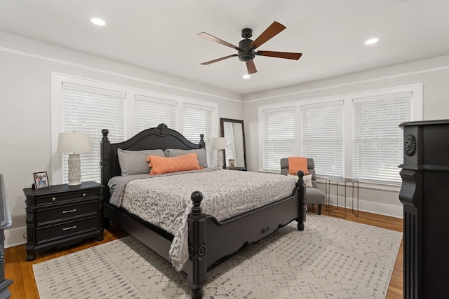 bedroom with recessed lighting, baseboards, and wood finished floors