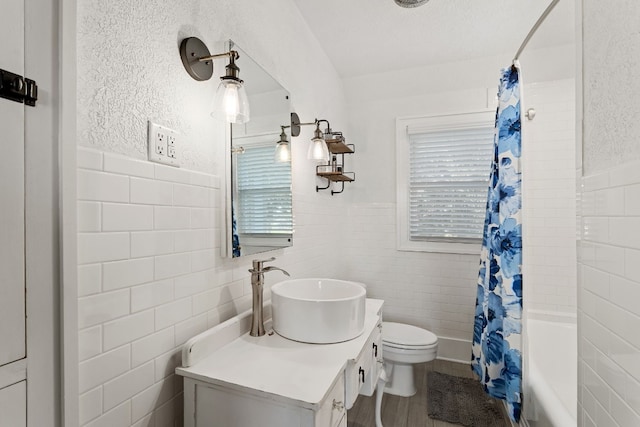 bathroom featuring vanity, tile walls, and a healthy amount of sunlight