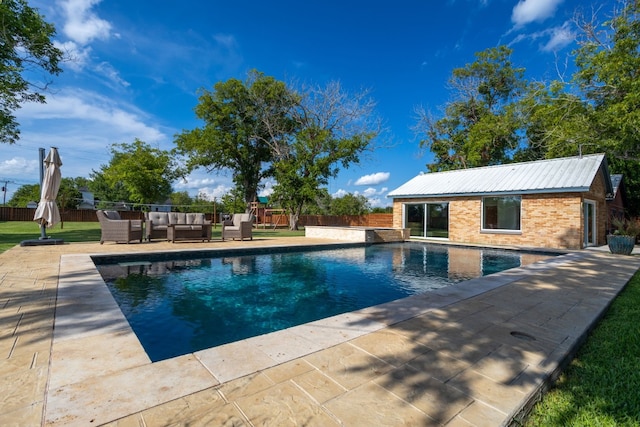 view of swimming pool with a patio area, fence, outdoor lounge area, and a fenced in pool