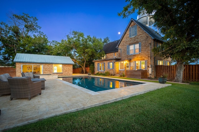 view of swimming pool with a patio, an outbuilding, a storage structure, fence private yard, and a yard