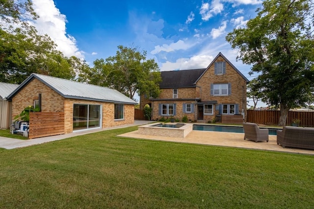 back of property featuring a lawn, an outdoor hangout area, a patio area, fence, and an in ground hot tub