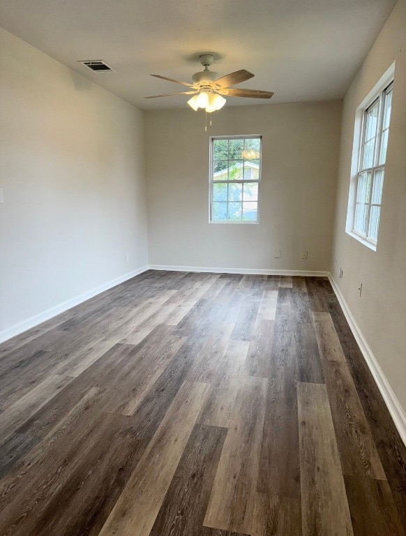 empty room featuring dark hardwood / wood-style flooring and ceiling fan