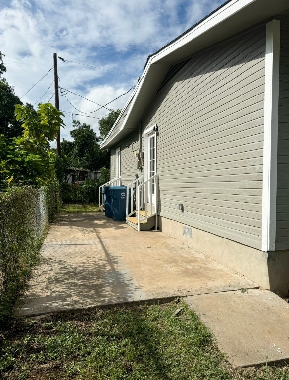 view of side of home featuring a patio