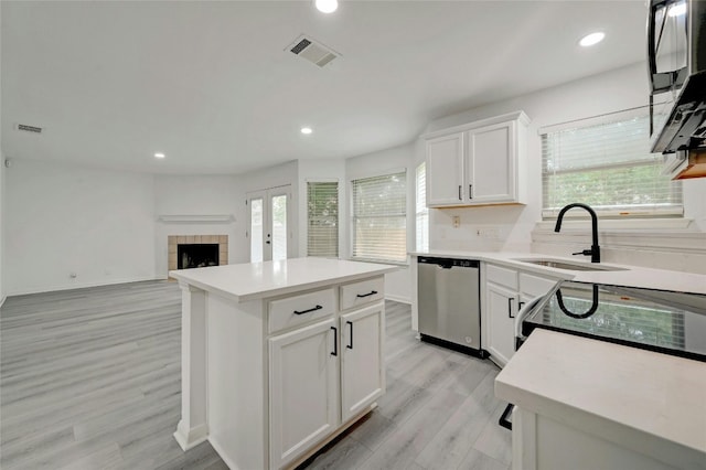 kitchen featuring a center island, stainless steel appliances, a wealth of natural light, and sink