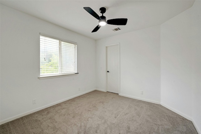 carpeted spare room with ceiling fan