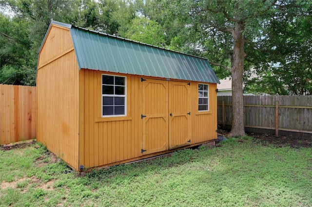 view of outbuilding featuring a yard