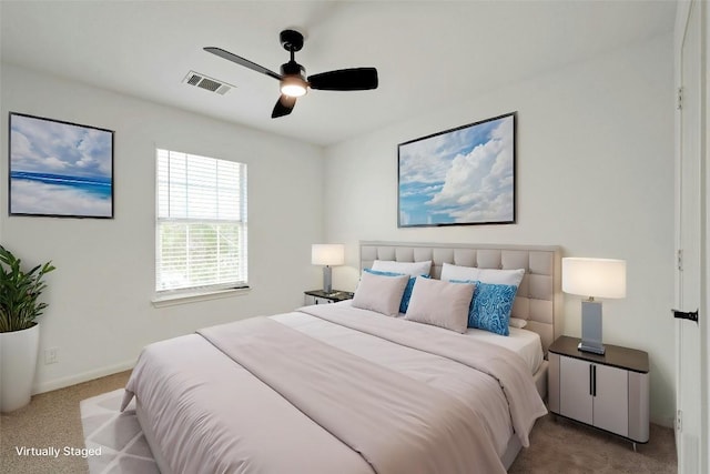 bedroom featuring light colored carpet and ceiling fan