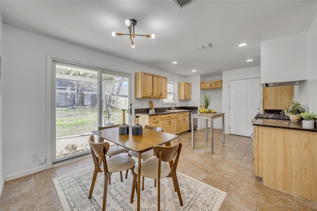 dining space featuring an inviting chandelier and sink