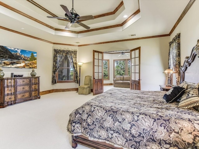 6000 Lantern View Dr, Jonestown, TX 78645 - carpeted bedroom with ornamental molding, a tray ceiling, and a ceiling fan