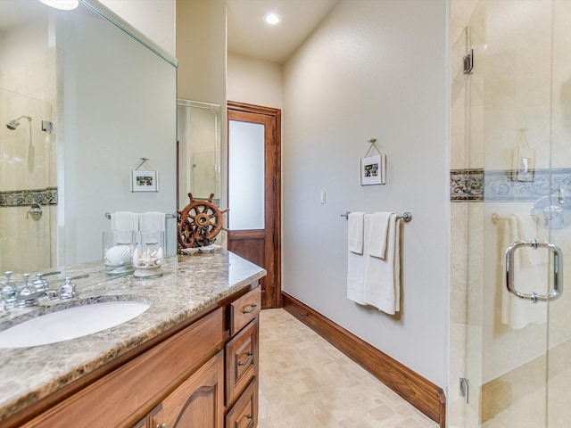 bathroom with vanity and a shower with shower door