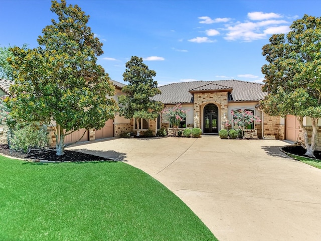 mediterranean / spanish home featuring a front lawn