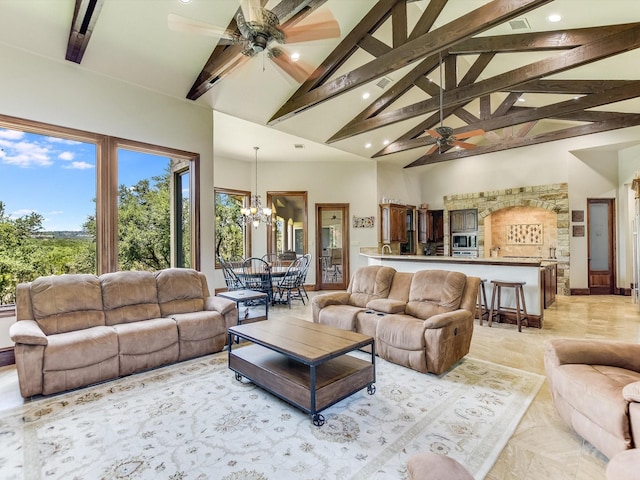 living room with beam ceiling, ceiling fan with notable chandelier, and high vaulted ceiling