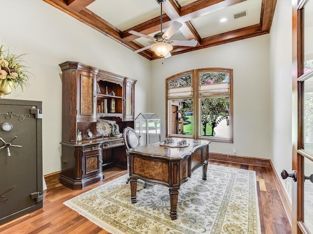 home office with ceiling fan, coffered ceiling, beam ceiling, and light hardwood / wood-style flooring